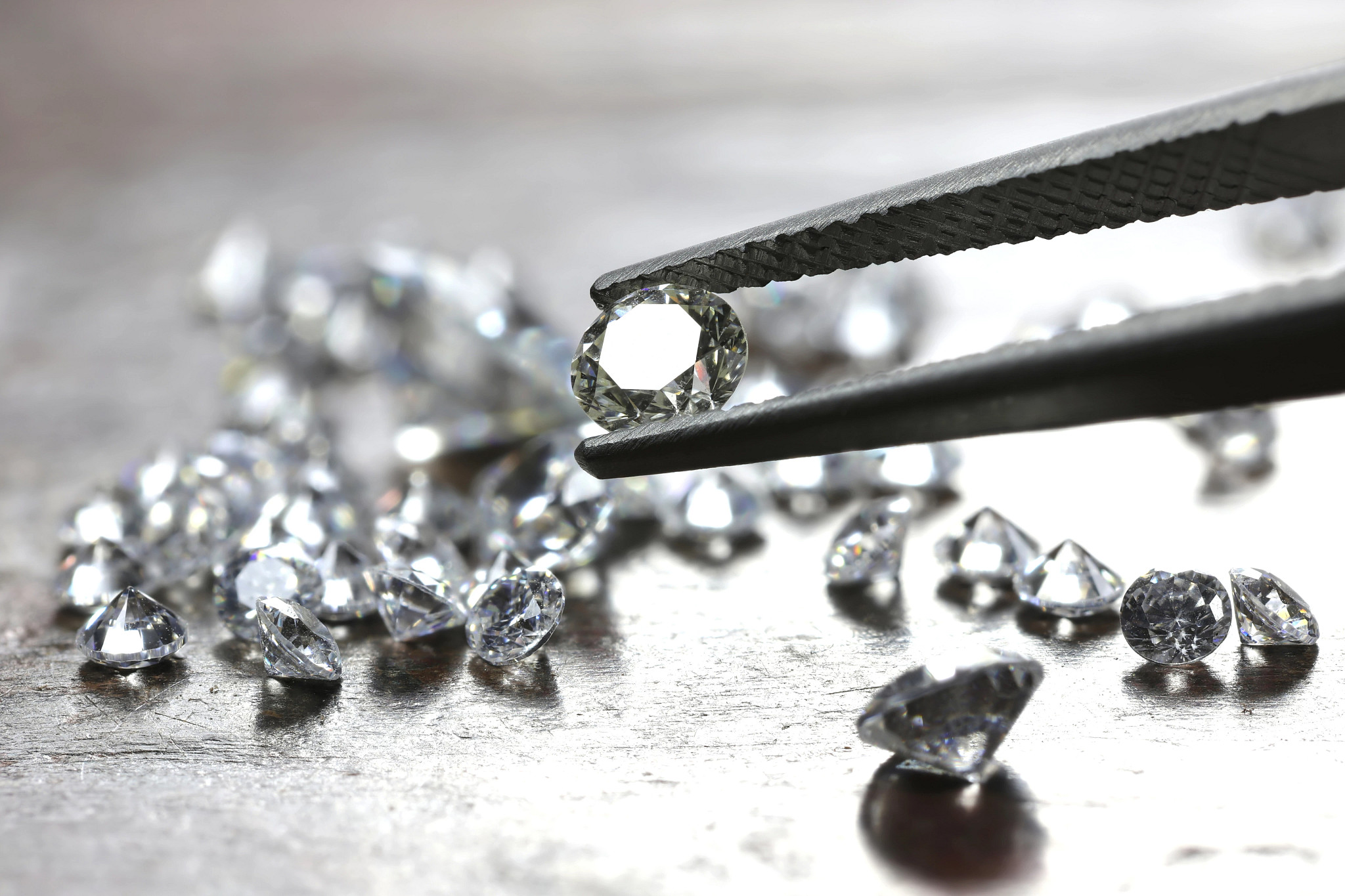 Diamonds held by tweezers