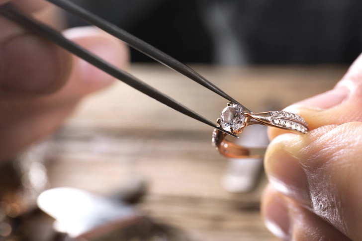 Jeweler mounting a diamond in a ring
