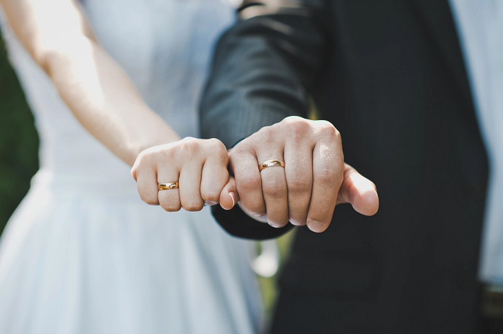 Married couple showing their rings
